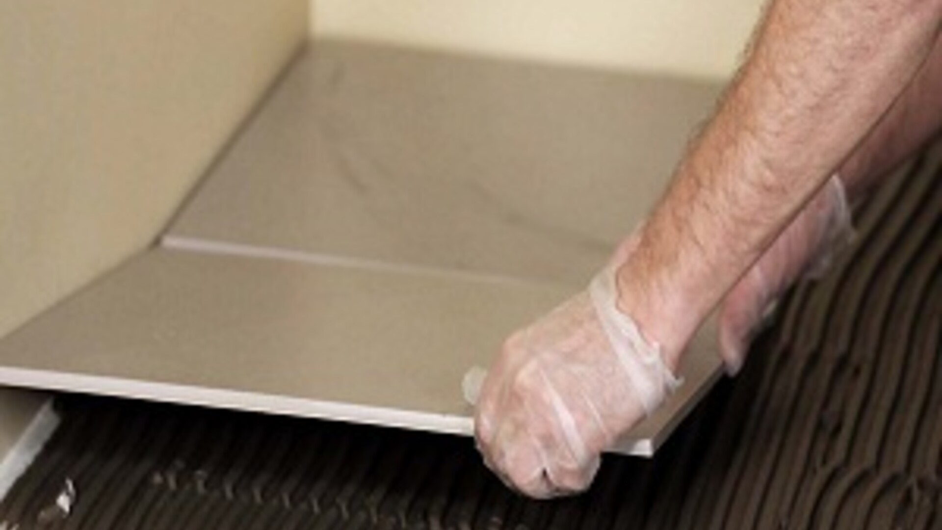 Laying tile on grey tile adhesive Laying tile on grey tile adhesive