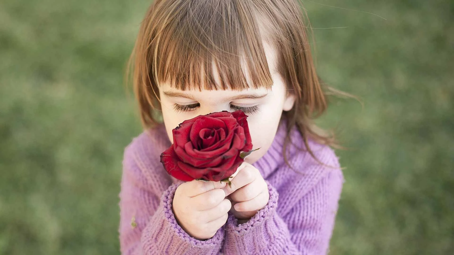 Girl smelling fresh flowers