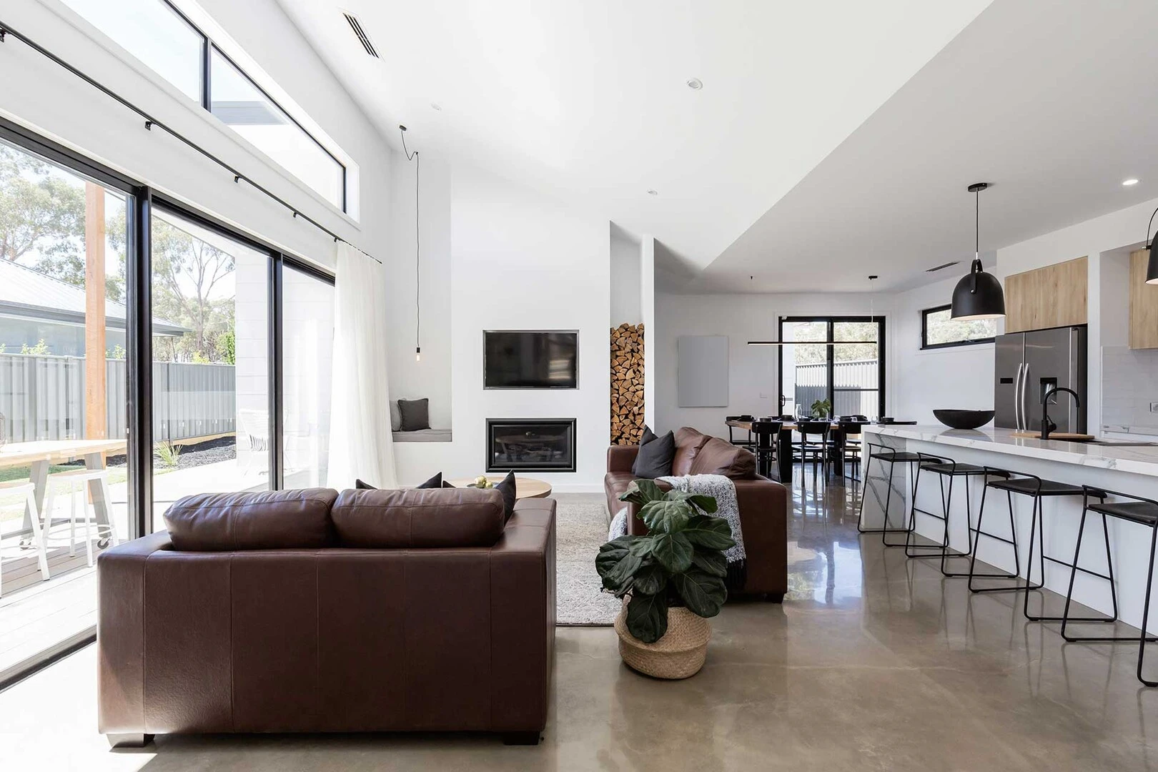 Open plan kitchen diner with polished concrete floor 